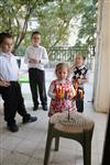 A child lights a menorah at the entrance facing the public domain