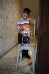 A child lights a menorah at the entrance facing the public domain