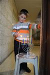 A child lights a menorah at the entrance facing the public domain