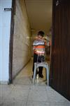 A child lights a menorah at the entrance facing the public domain