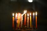 A child lights a menorah at the entrance facing the public domain