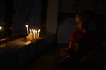 A child lights a menorah at the entrance facing the public domain