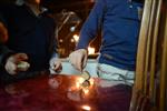 Child playing dreidel during the Hanukkah holiday by the menorah lit