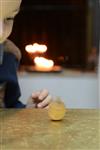 Child playing dreidel during the Hanukkah holiday by the menorah lit