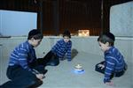 Child playing dreidel during the Hanukkah holiday by the menorah lit