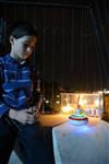 Child playing dreidel during the Hanukkah holiday by the menorah lit