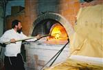 Unleavened bread are baked in a special oven for Kosher for Passover matzos