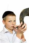 boy blows in the shofar