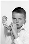 boy blows in the shofar