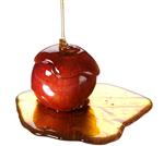 honey pouring on an apple