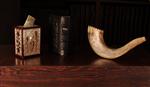 a shofar, a siddur and a tzedaka box