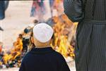 Father and son burn chametz on Passover eve