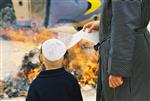 Father and son burn chametz on Passover eve