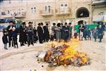 Father and son burn chametz on Passover eve