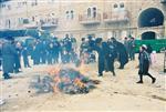 Father and son burn chametz on Passover eve