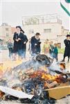 Father and son burn chametz on Passover eve