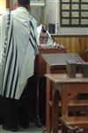 Jews praying in the synagogue with prayer shawl and phylacteries