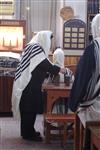 Jews praying in the synagogue with prayer shawl and phylacteries