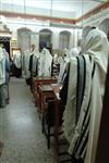 Jews praying in the synagogue with prayer shawl and phylacteries
