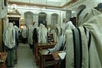 Jews praying in the synagogue with prayer shawl and phylacteries