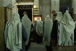 Jews praying in the synagogue with prayer shawl and phylacteries