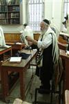 Jews praying in the synagogue with prayer shawl and phylacteries