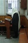 Jews praying in the synagogue with prayer shawl and phylacteries