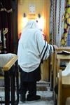 Jews praying in the synagogue with prayer shawl and phylacteries