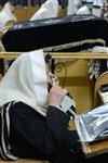 Jews praying in the synagogue with prayer shawl and phylacteries