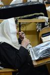 Jews praying in the synagogue with prayer shawl and phylacteries