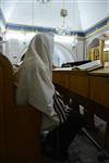 Jews praying in the synagogue with prayer shawl and phylacteries