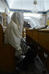 Jews praying in the synagogue with prayer shawl and phylacteries