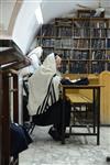 Jews praying in the synagogue with prayer shawl and phylacteries