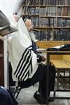 Jews praying in the synagogue with prayer shawl and phylacteries