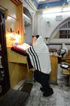 Jews praying in the synagogue with prayer shawl and phylacteries