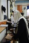 Jews praying in the synagogue with prayer shawl and phylacteries