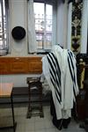 Jews praying in the synagogue with prayer shawl and phylacteries