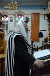 Jews praying in the synagogue with prayer shawl and phylacteries