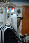 Jews praying in the synagogue with prayer shawl and phylacteries