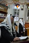 Jews praying in the synagogue with prayer shawl and phylacteries