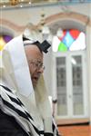 Jews praying in the synagogue with prayer shawl and phylacteries