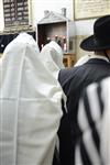 Jews praying in the synagogue with prayer shawl and phylacteries