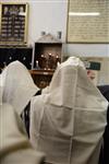 Jews praying in the synagogue with prayer shawl and phylacteries