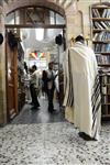 Jews praying in the synagogue with prayer shawl and phylacteries