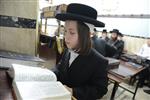 Jews praying in the synagogue with prayer shawl and phylacteries