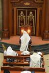 Jews praying in the synagogue with prayer shawl and phylacteries