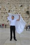 Talit and Tefilin Laying against the background the Western Wall in Jerusalem