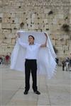 Talit and Tefilin Laying against the background the Western Wall in Jerusalem