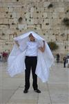 Talit and Tefilin Laying against the background the Western Wall in Jerusalem