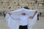 Talit and Tefilin Laying against the background the Western Wall in Jerusalem